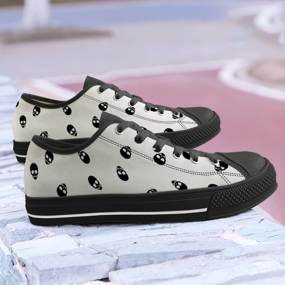 White Canvas Low Top Sneakers with a Jaw-Dropping Black Skull Pattern - Get ready to steal the show and make the Grim Reaper green with envy!