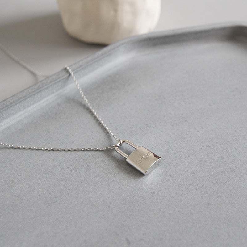 Sleek 925 sterling silver necklace featuring a freedom lock pendant, symbolizing liberation and elegance in a chic design.