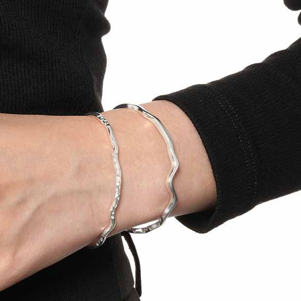 Minimalist and modern open bangle made from 925 sterling silver, featuring an elegant irregular design for a unique style statement.